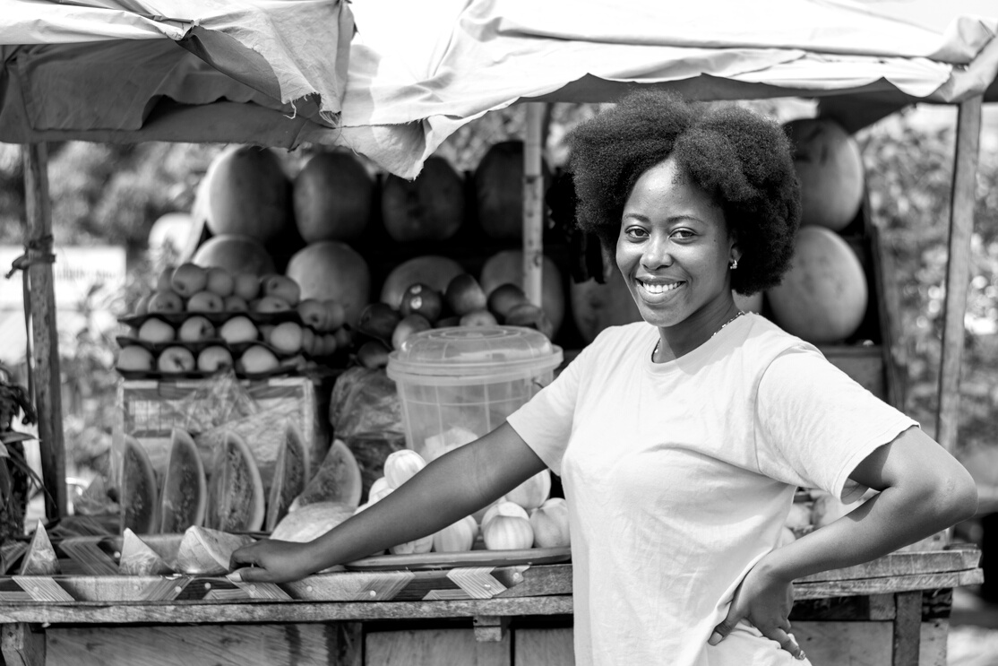 portrait of young african woman selling fruits